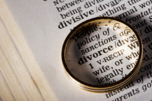 The word divorce in the dictionary, circled by a wedding ring