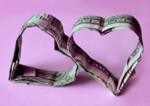 Two dollar bills folded into the shape of hearts